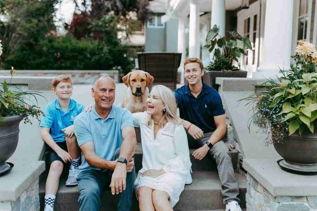 Family of four sitting on steps
