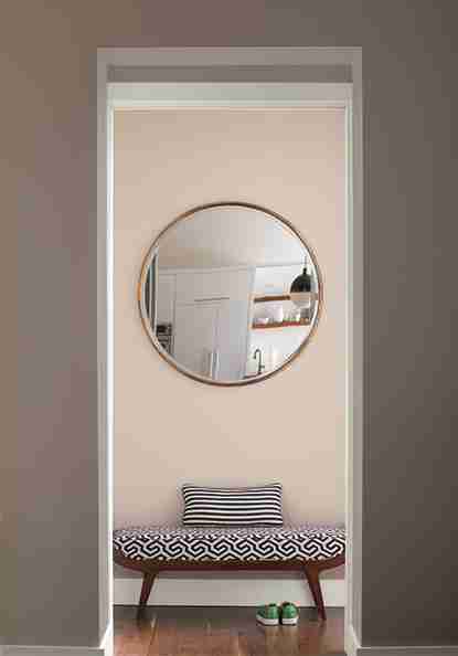 Peachy Paint color on wall with round mirror