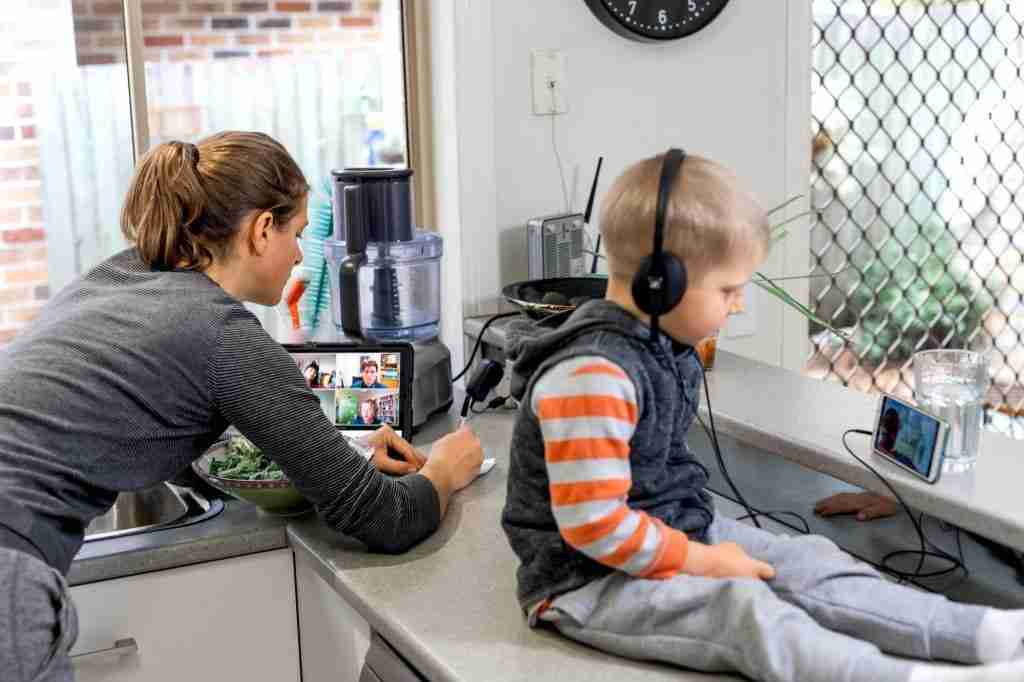 Woman and child in the kitchen using technology