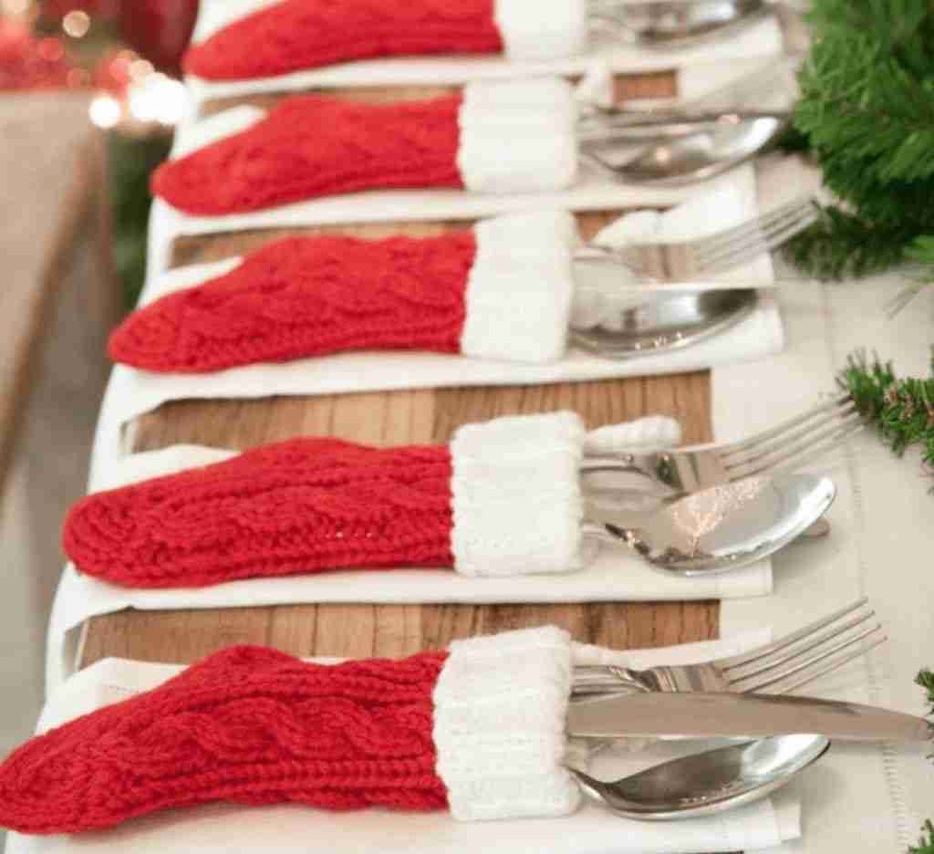 Holiday stockings on the table with knives, fork and spoon in stocking