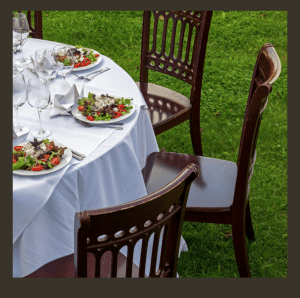 Table set outside with white linen