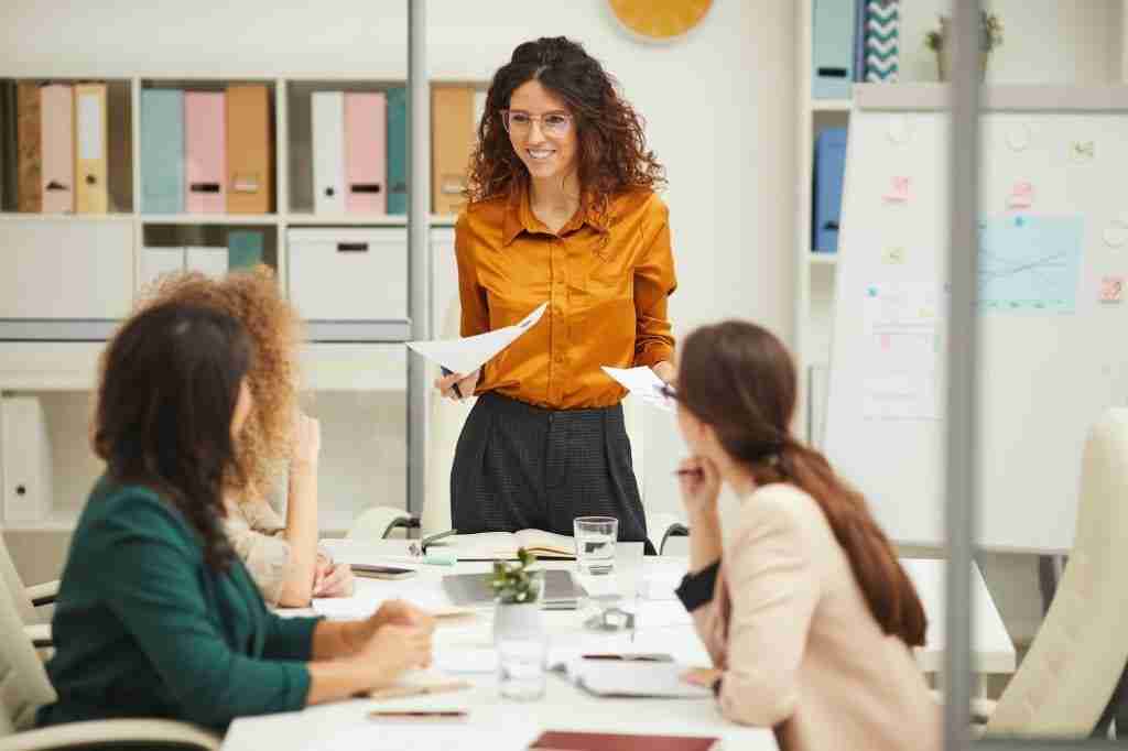 Woman With Curly Hair At Meeting