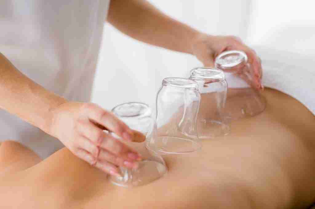 Masseur giving suction massage to woman