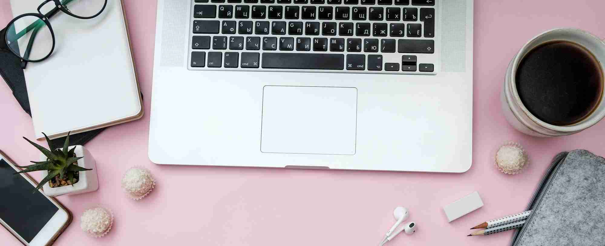 Pink pastel woman office desk with laptop, notebook and phone Pink pastel woman office desk with laptop, notebook and phone