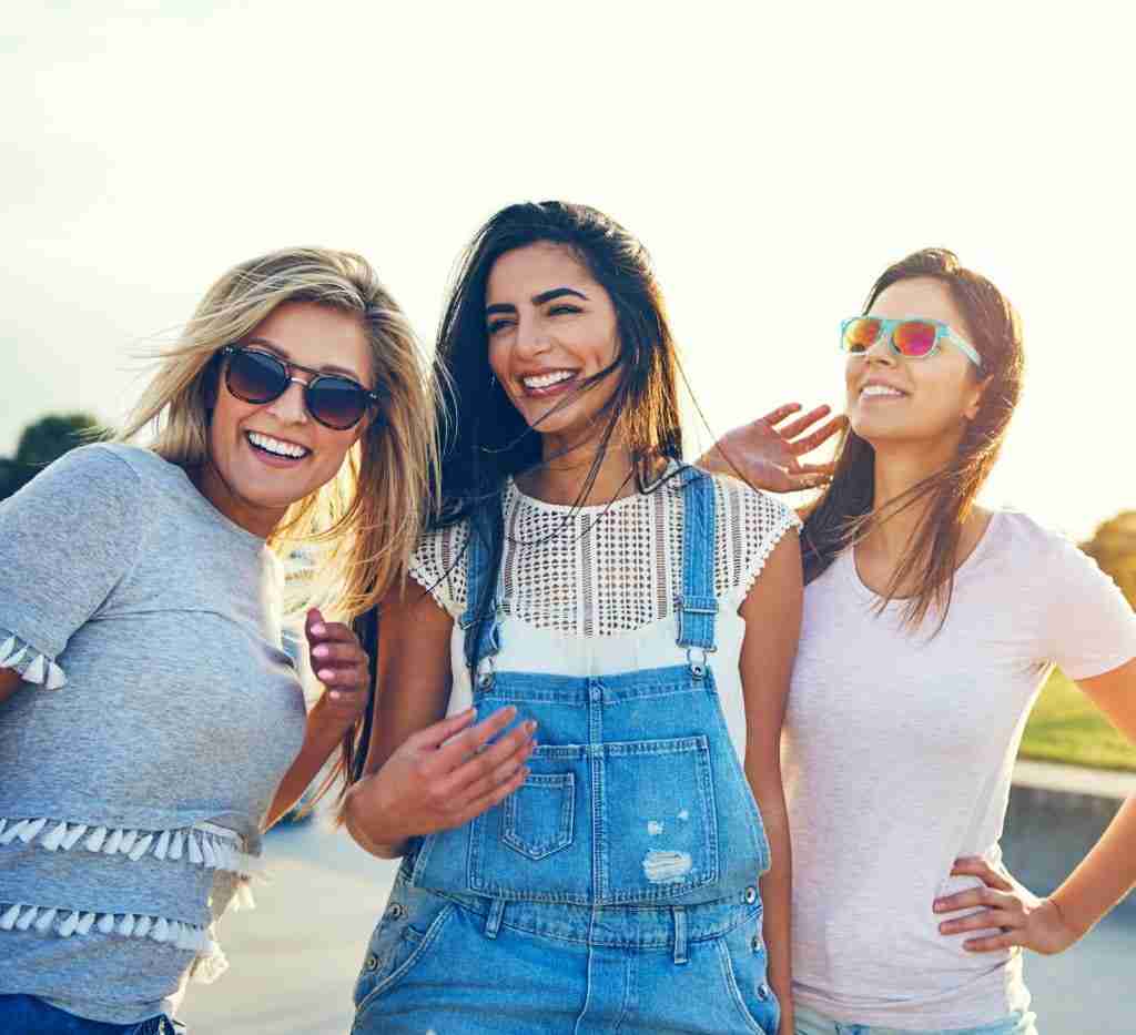 Three multiracial women friends at the seaside