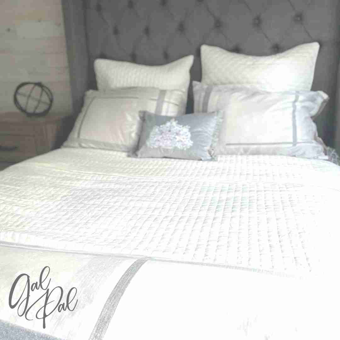 Ivory Coverlet on bed with gray headboard