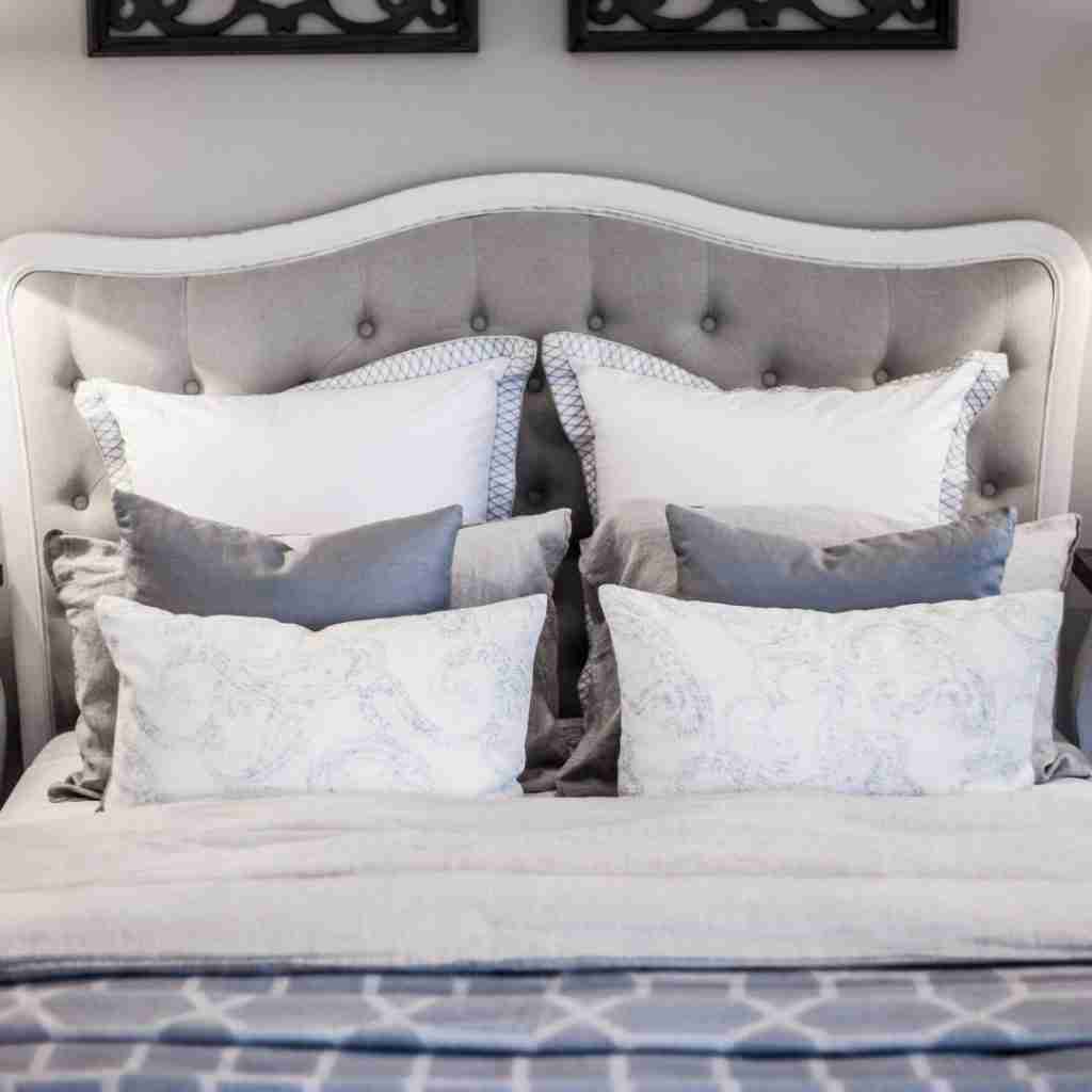 A elegant layered bed with lots of pillows. Cozy and elegant