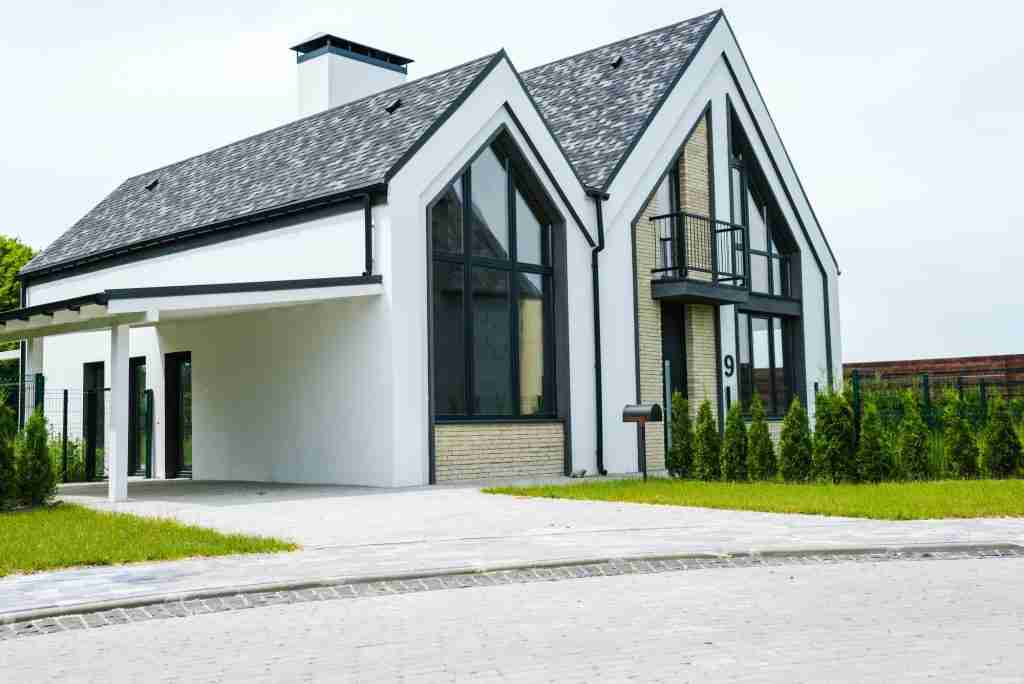 new modern and luxury home with windows and doors near green grass
