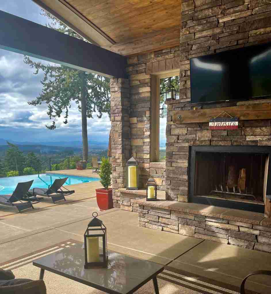 Outdoor fireplace with TV above for the best outdoor living 