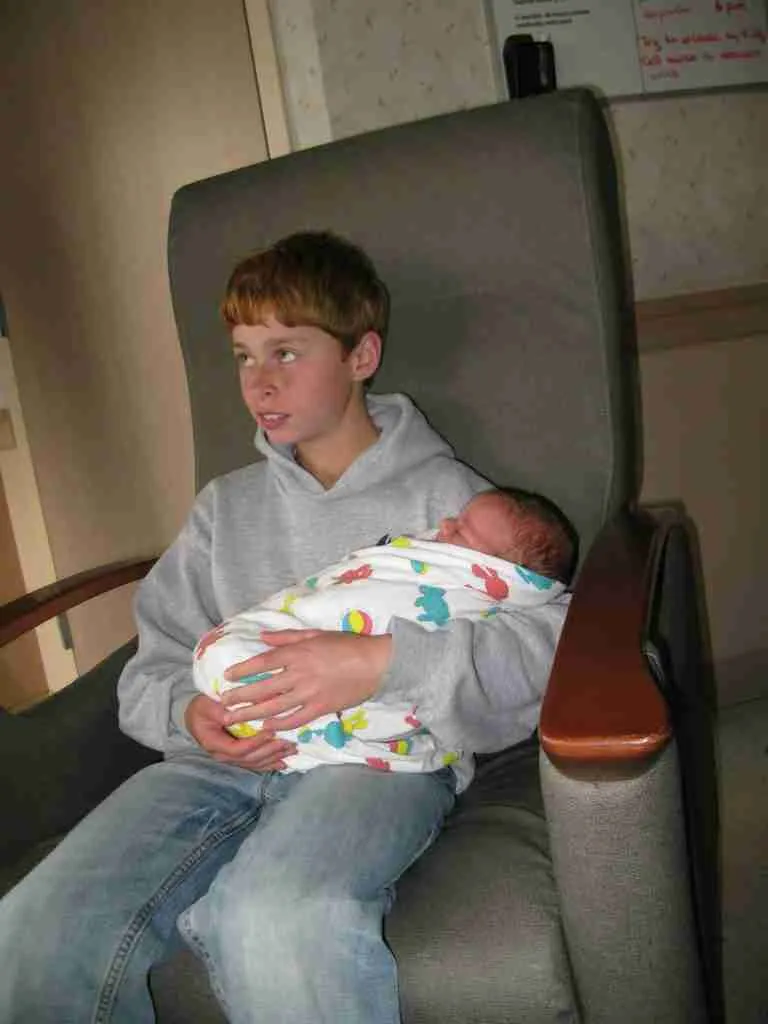 Boy holding baby