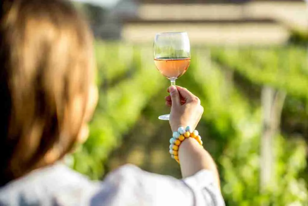 Woman tasting wine outdoors
