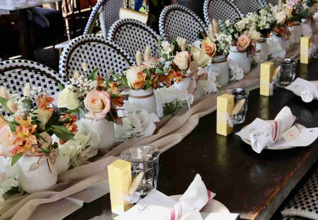 Long table with floral arrangements down the center of the table