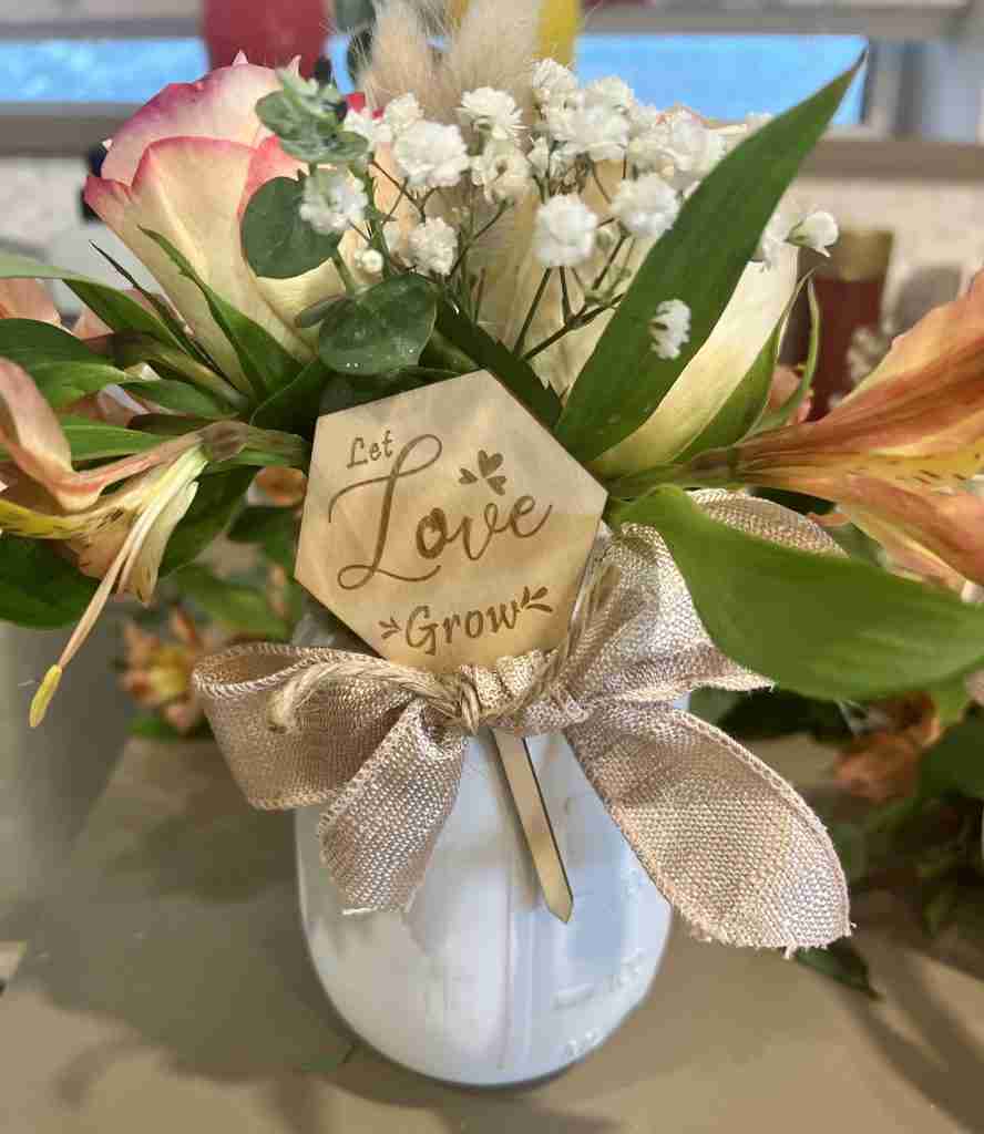 White mason jars-painted with floral arrangement for bridal shower