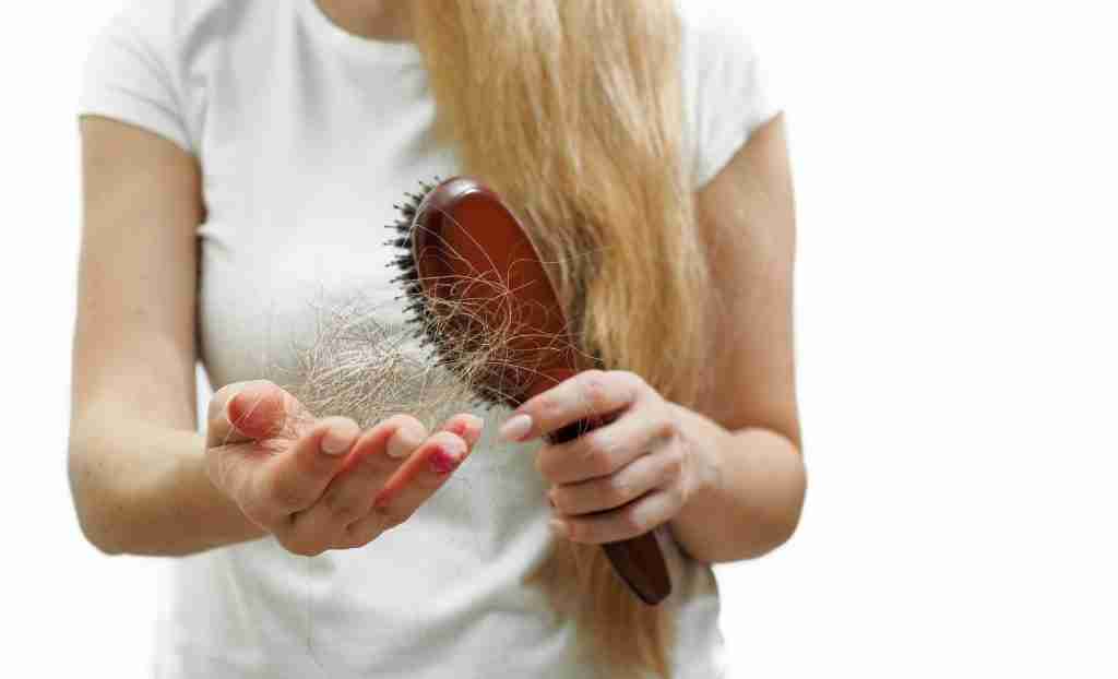 The problem of hair loss in women. Long and thick hair stays on the comb. Banner with space for text