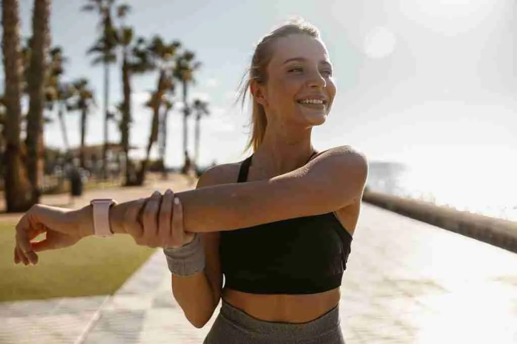 Beautiful athletic woman relaxing outdoors in morning