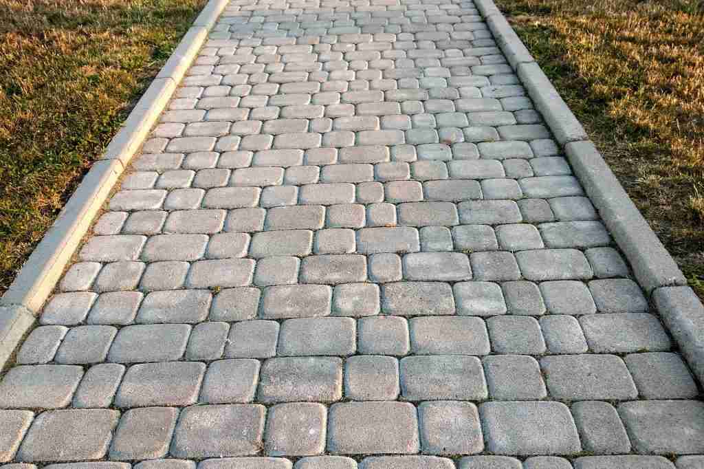 Close-up of slab stone paved path way at park or backyard. Walkway footpath road at house yard