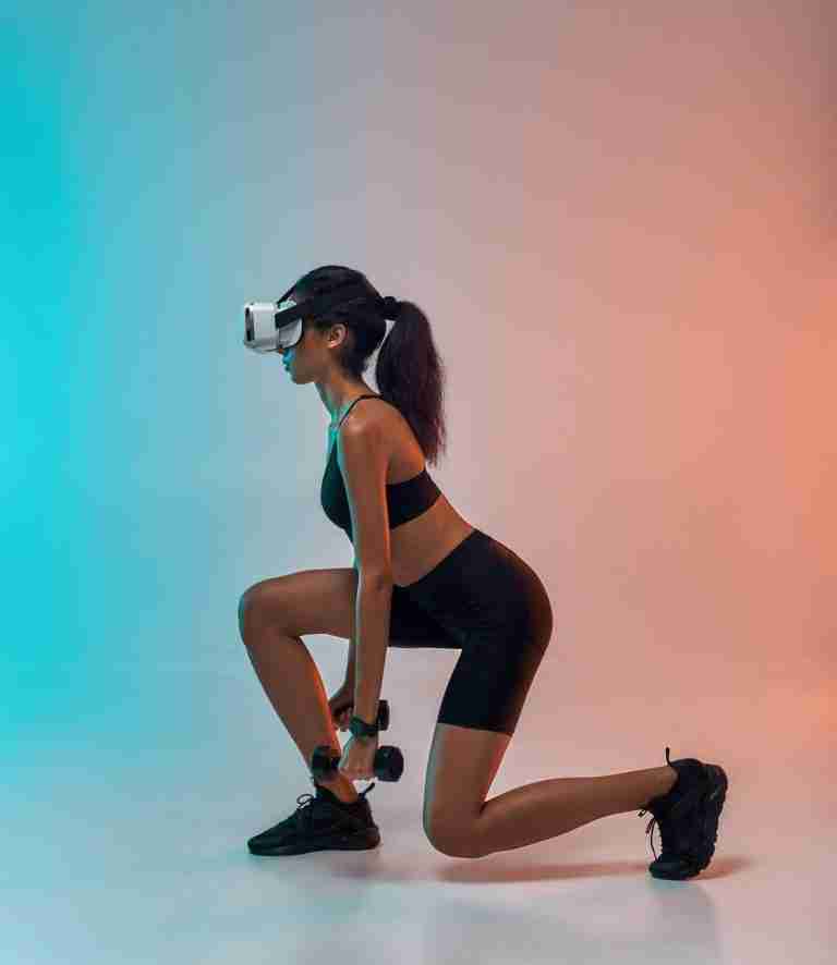 Future technology. Side view of young sporty woman in sports clothing exercising with dumbbells