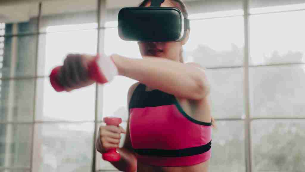 Young Asian woman wearing virtual reality glasses while working out at home.