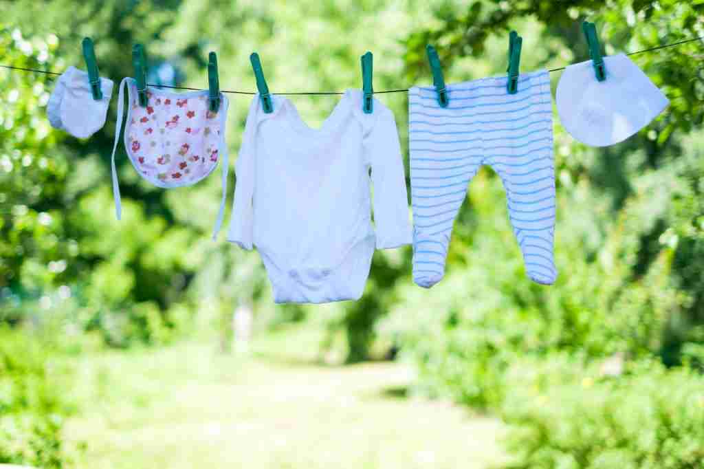Baby clothes on clothesline in garden