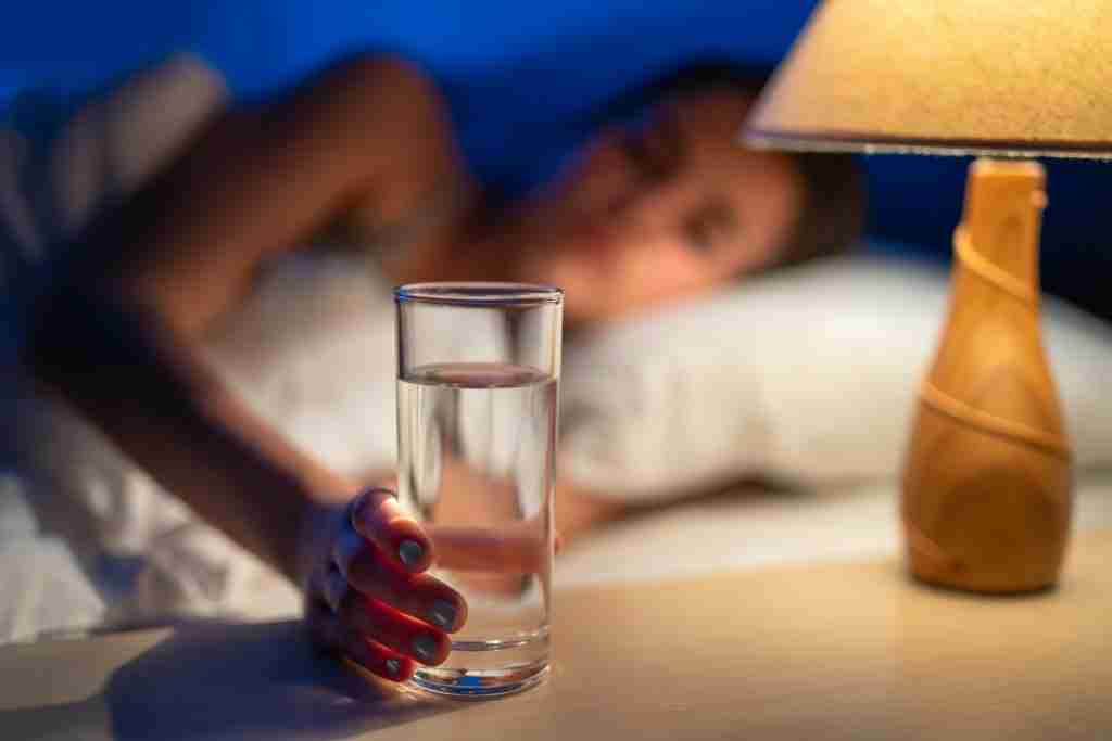 The sleeping woman holding an alcohol shot