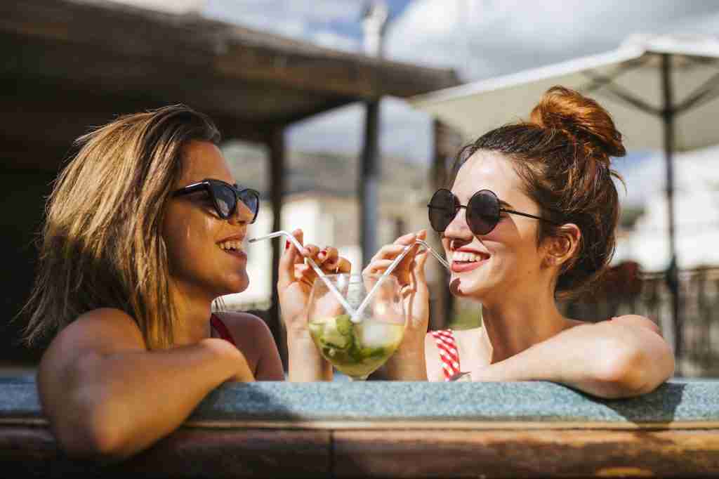 Two women having a drink in a jacuzzi