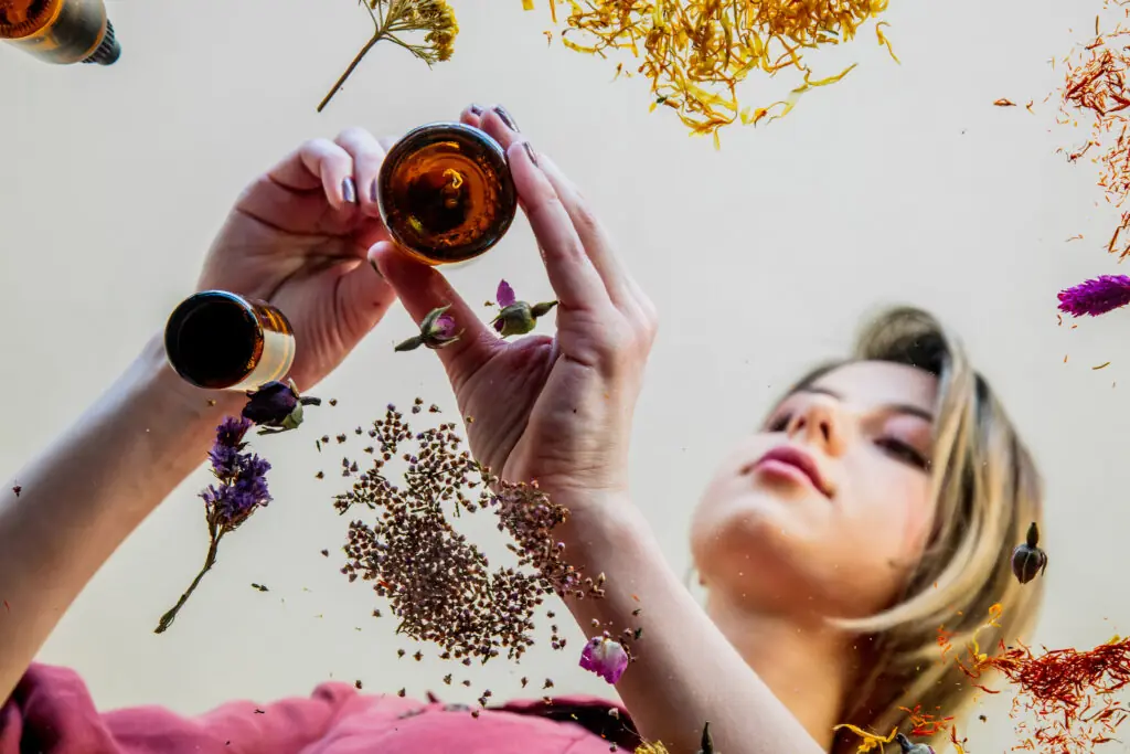 woman perfumer preparing herbs and flowers for make a perfume.