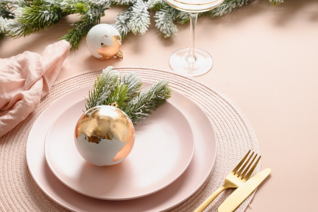 Holiday dinner party. Christmas, New Year pink and gold table setting for celebration holidays.
