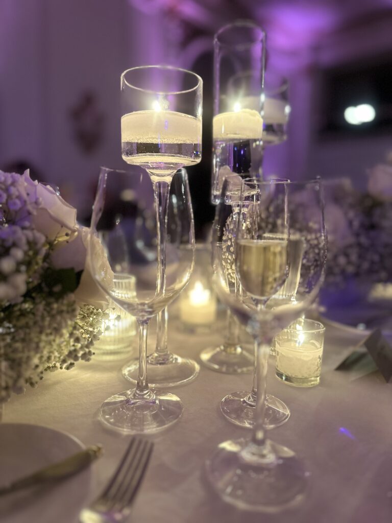 Candle light on dinner table with wine glasses