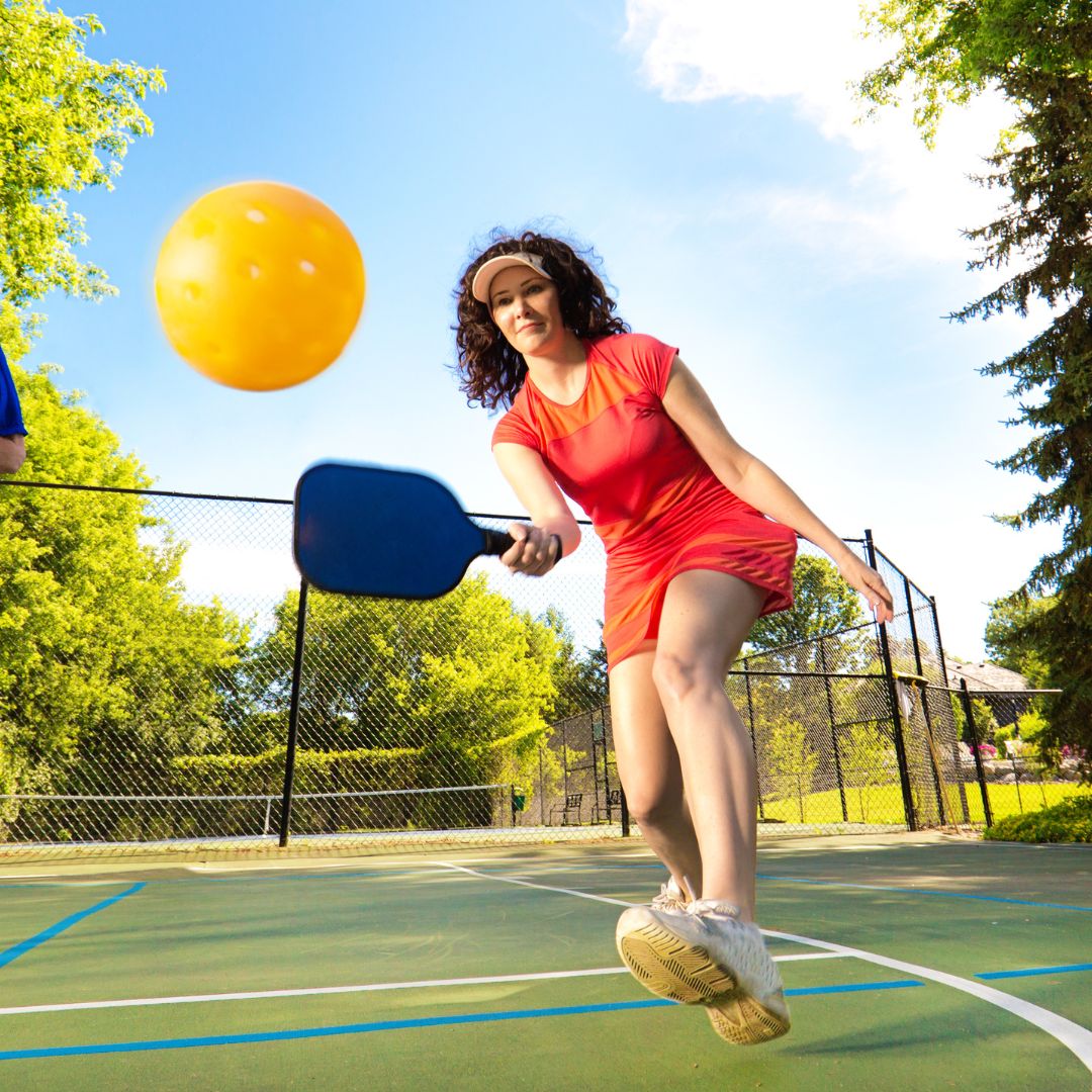 woman playing pickleball on the court with pickleball shoes