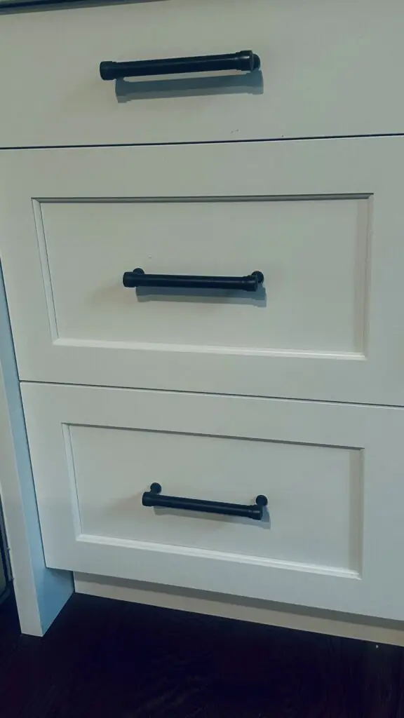 White kitchen cabinets with oil rubbed bronze finish
