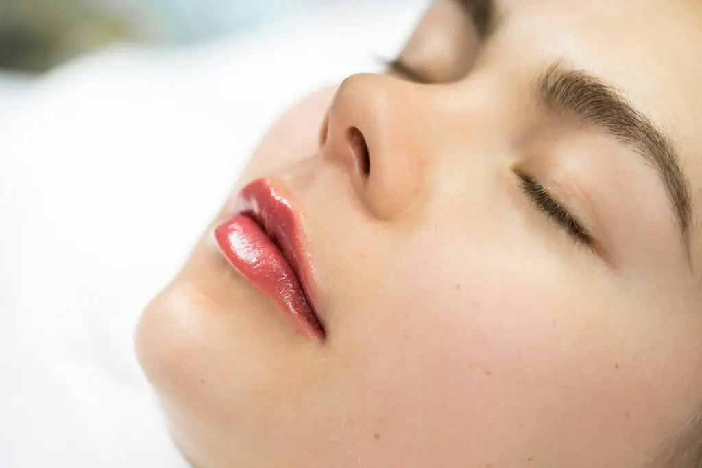 Female lips after permanent makeup lip blushing procedure