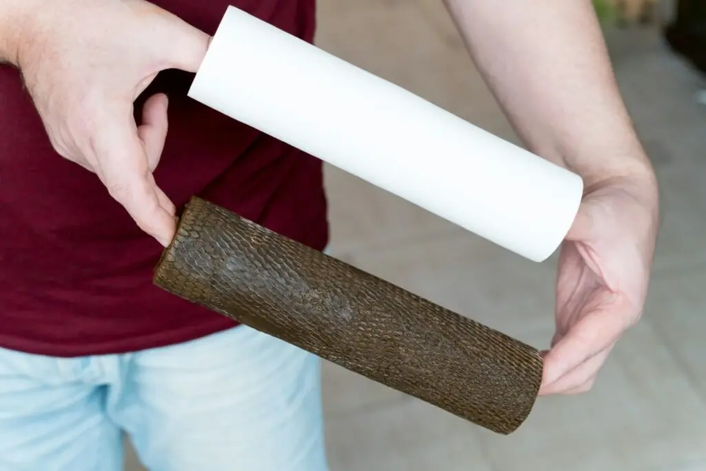 two water filter cartridges - clean and dirty - in men's hands, clearance, unit, changing, insert