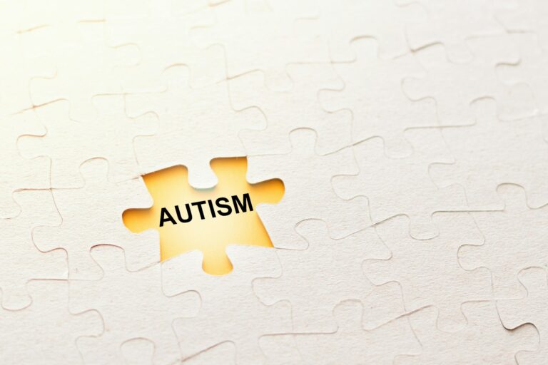 Missing puzzle piece with inscription autism on a yellow background, problem concept