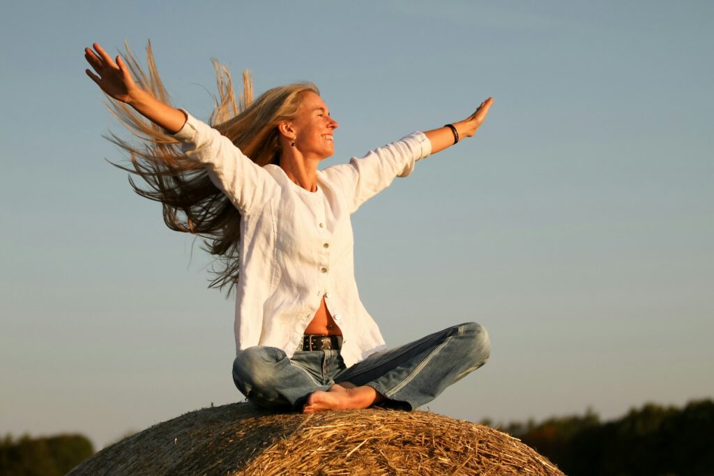 Young woman with flying long hair celebrating life. Longer life span is possible. 