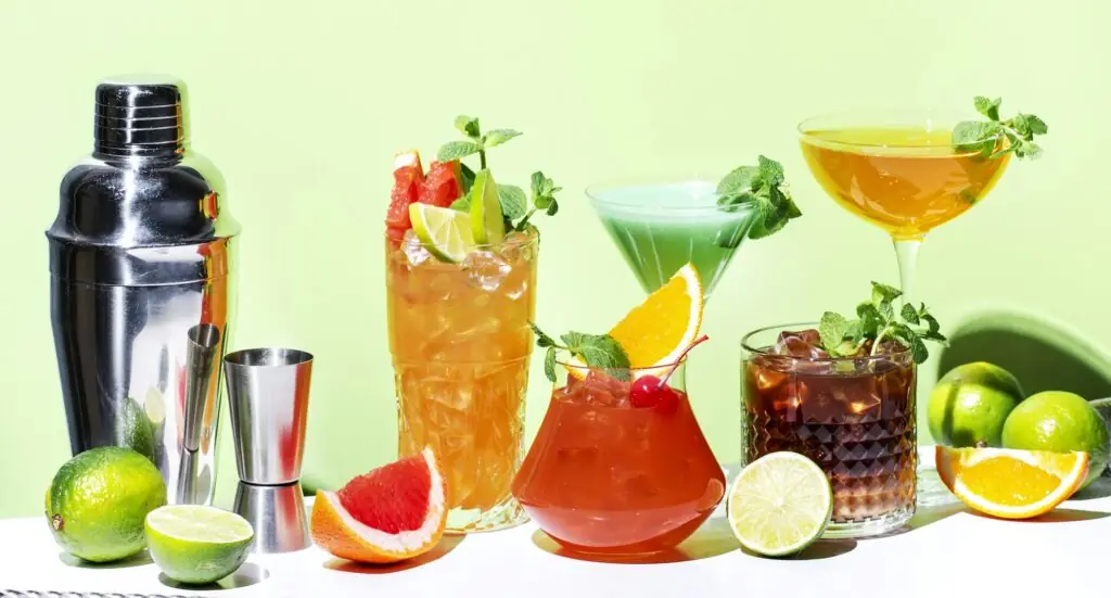 Alcoholic beverages, summer cocktail party. Multicolored low alcohol drink glasses set