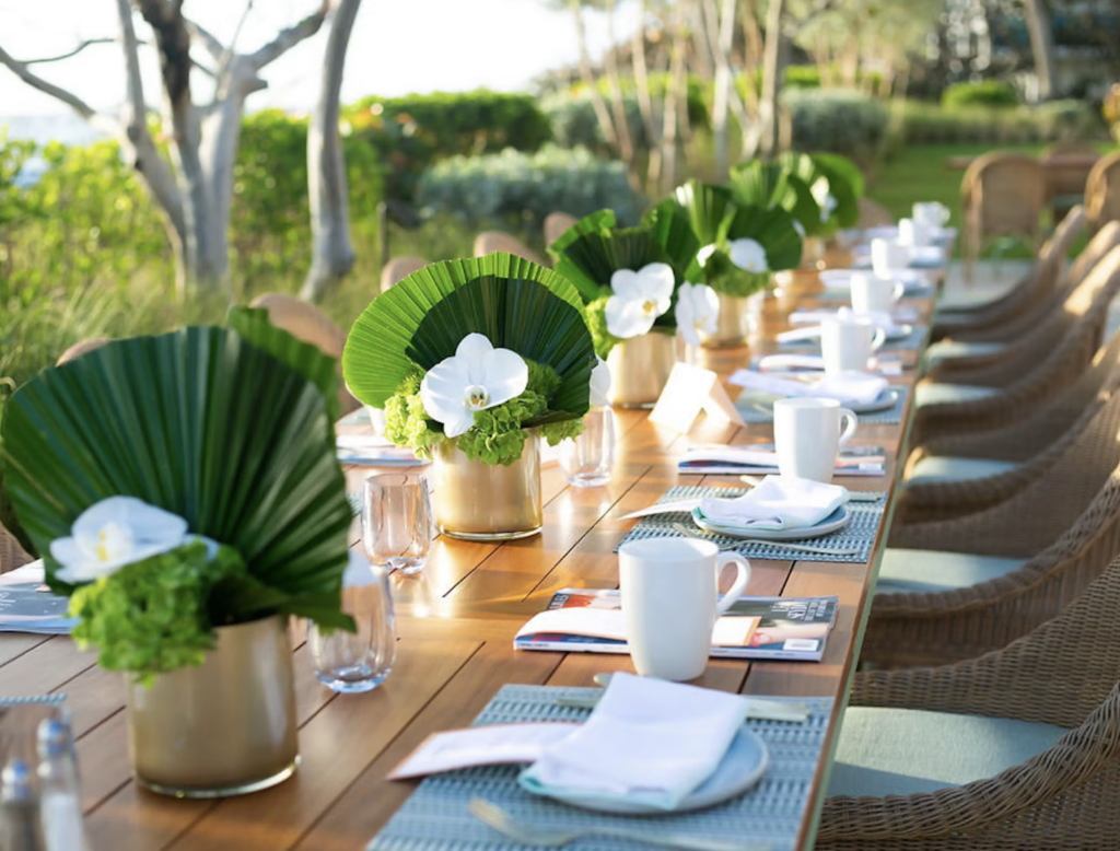 Simple centerpieces outside with palm leaves