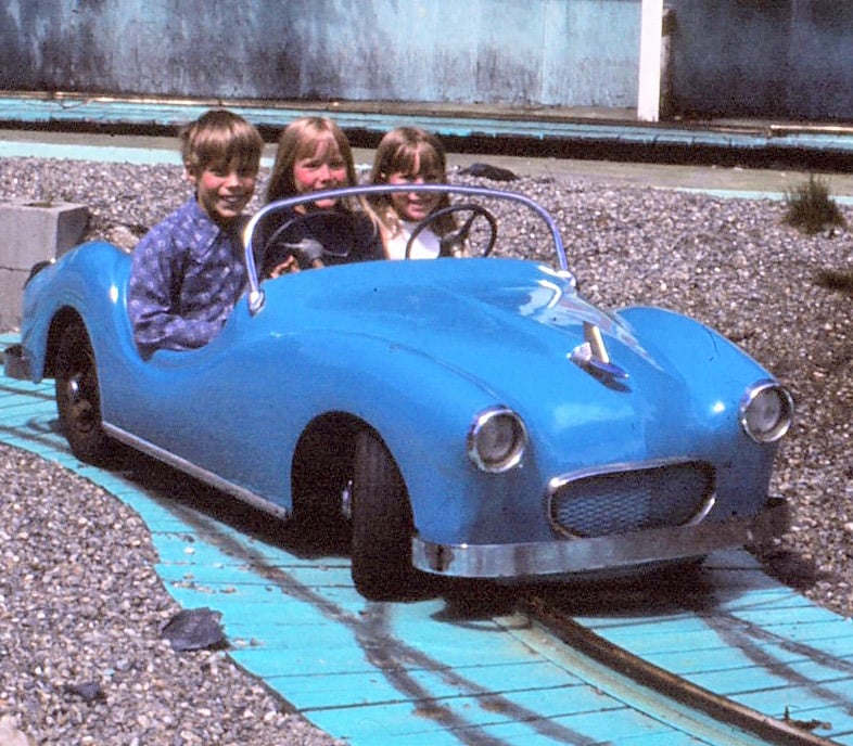 My siblings in a small car on tracks. photo was taken by my Dad who now has passed.