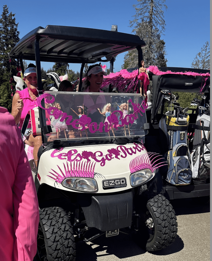 pink and white barbie golf cart with eye lashes